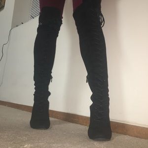 Thigh high black boots with tie up laces
